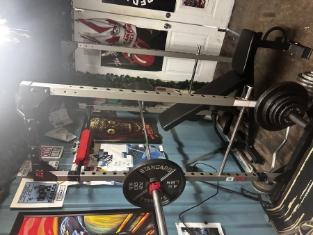 Fitness rack with weights and bar